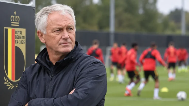 Een staflid observeert een oefensessie van België naast een vast bord van de Belgische voetbalbond.