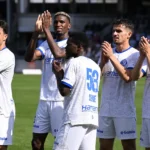 Een groep KAA Gent-spelers viert samen op het veld na de wedstrijd.