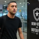 Hakim Ziyech in de aankomsthal van luchthaven Galeão bij een welkomstbord van Botafogo.