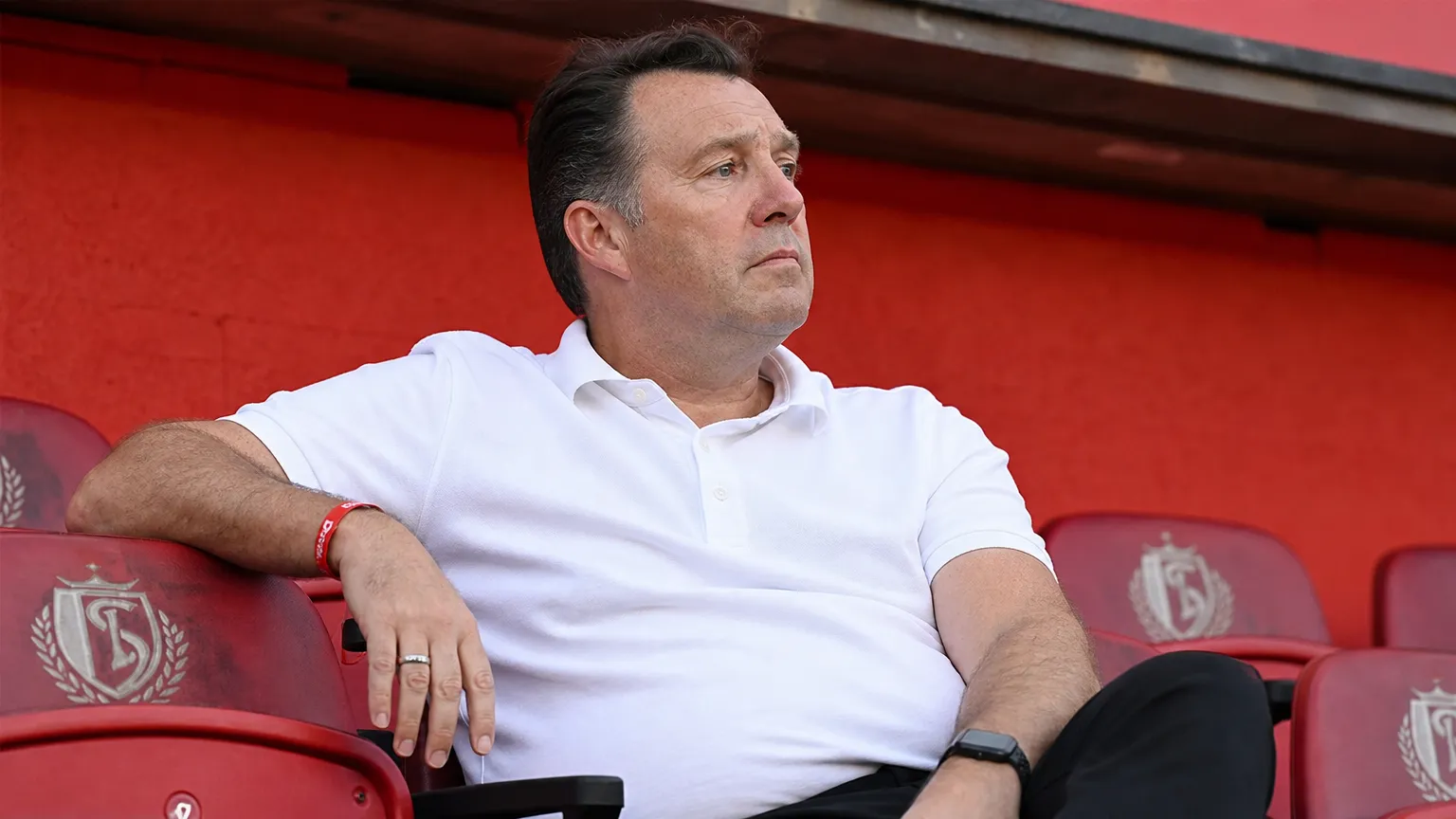 Marc Wilmots kijkt aandachtig toe vanuit de tribune van Standard.