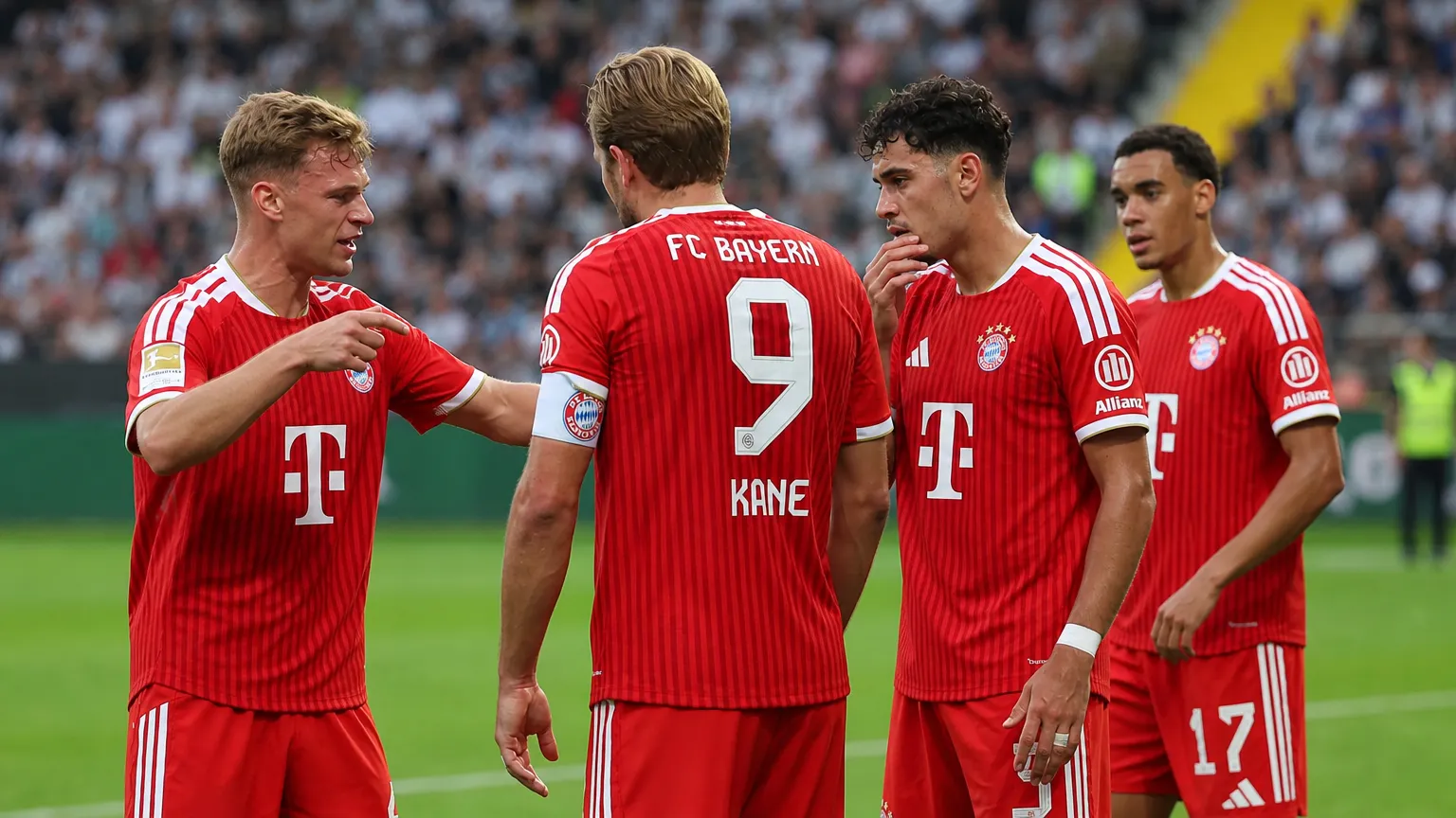 Een groep spelers van Bayern München overlegt op het veld tijdens een Bundesliga-wedstrijd.
