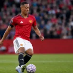 Youri Tielemans controleert de bal in het rode shirt van Manchester United.