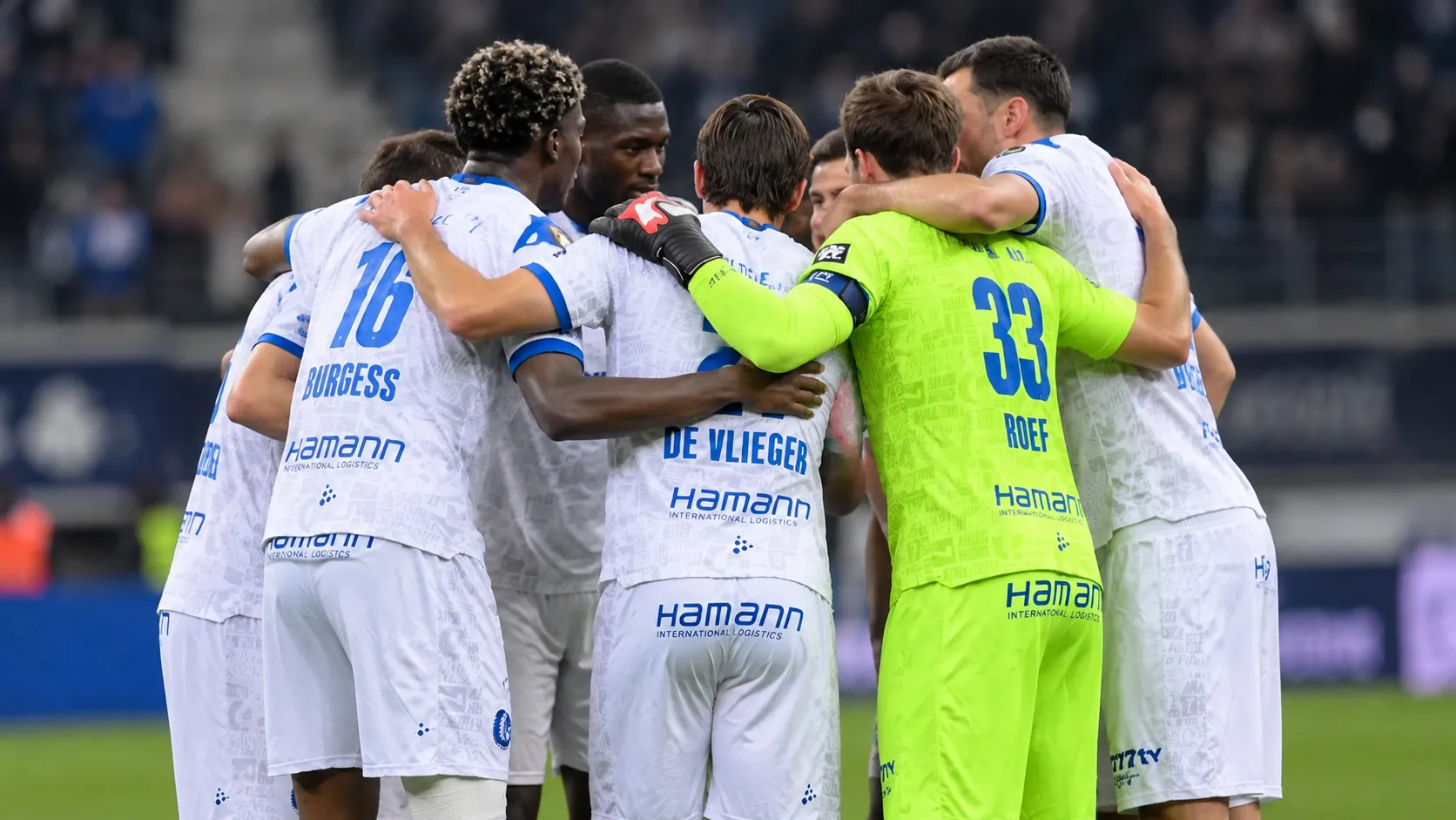 Spelers van KAA Gent vormen na een wedstrijd een hechte kring op het veld.