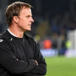 Vincent Euvrard in een zwart trainingsbovenstuk langs de zijlijn na een wedstrijd.