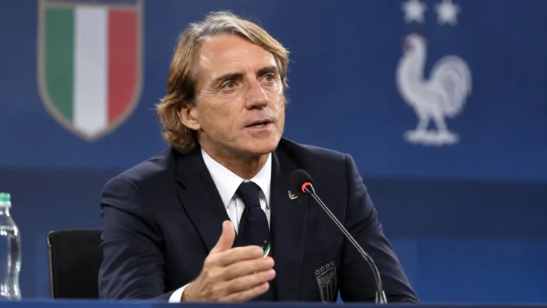 Roberto Mancini spreekt in een persconferentiezaal in zijn donkere Italiaanse bondscoachpak.