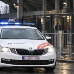 Politievoertuig aan de toegangszone van het Jan Breydelstadion met een Club Brugge-embleem op een vast stadionbord.