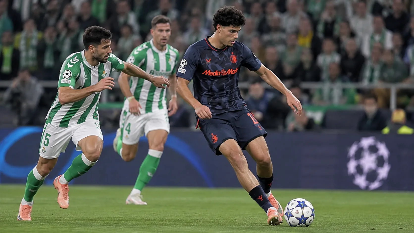 Een Feyenoord-speler in donker tenue tijdens een wedstrijdmoment tegen Real Betis.