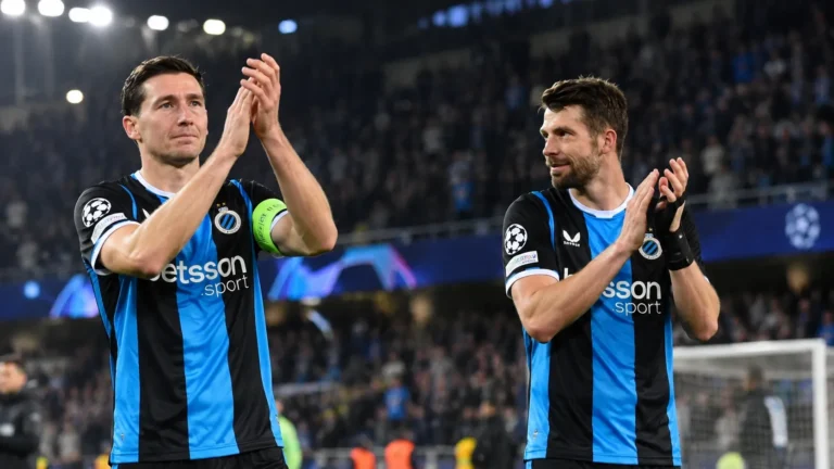 Twee spelers van Club Brugge applaudisseren na de wedstrijd voor de supporters.