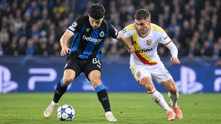 Twee voetballers van Club Brugge en RC Lens in een duel tijdens een Champions League-wedstrijd.