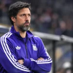 Vitor Bruno in paarse Anderlecht-trainingsjas langs de zijlijn van een stadion.
