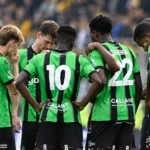 Een groep spelers van Cercle Brugge in groen-zwarte shirts verzamelt zich na de wedstrijd op het veld.