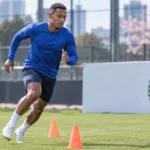 Josué Vergara tijdens een training op een veld in Tokio, met een bord van de Panamese voetbalbond langs de zijlijn.