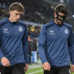 Twee spelers van Club Brugge lopen na een wedstrijd langs de zijlijn.