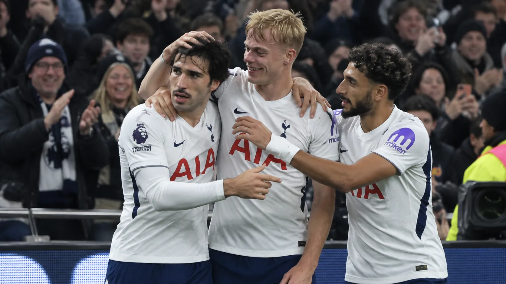 Tottenham-spelers vieren samen een doelpunt voor de tribune.