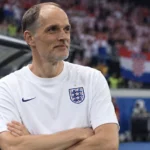 Thomas Tuchel in een wit Engeland-shirt aan de zijlijn na een wedstrijd.