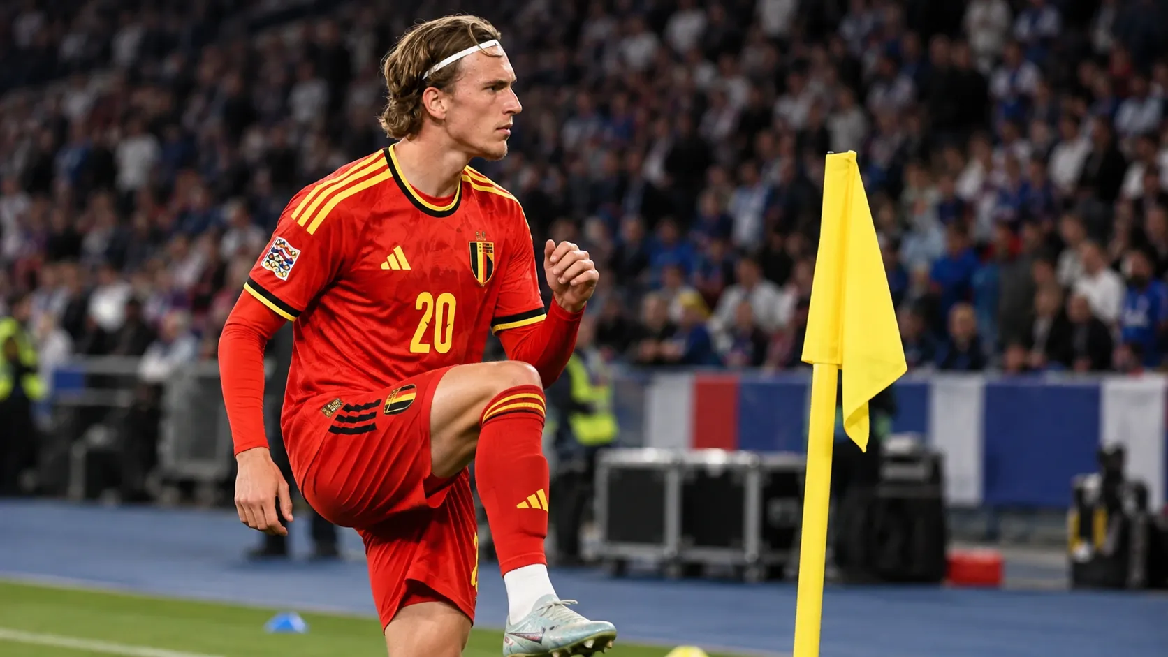 Mika Godts in een rood Belgisch tenue tijdens een opwarming aan de zijlijn van het Stade de France.