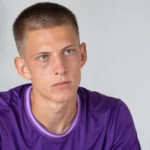 Lars Montegnies in een paarse voetbaltrui tijdens een rustig redactioneel portret.