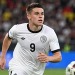 Nicolo Tresoldi in het witte shirt van Duitsland op het voetbalveld.