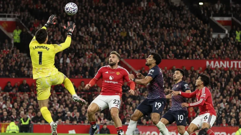 Een doelman en meerdere spelers in actie voor doel tijdens een wedstrijd op Old Trafford.