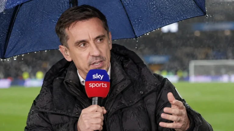 Gary Neville spreekt met een Sky Sports-microfoon vanuit een overdekte uitzendpositie naast het veld.