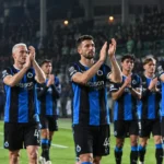 Een groep spelers van Club Brugge applaudisseert na een uitwedstrijd.