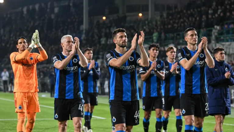 Een groep spelers van Club Brugge applaudisseert na een uitwedstrijd.