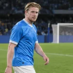 Kevin De Bruyne wandelt na een wedstrijd van Napoli op het veld in een blauw tenue.