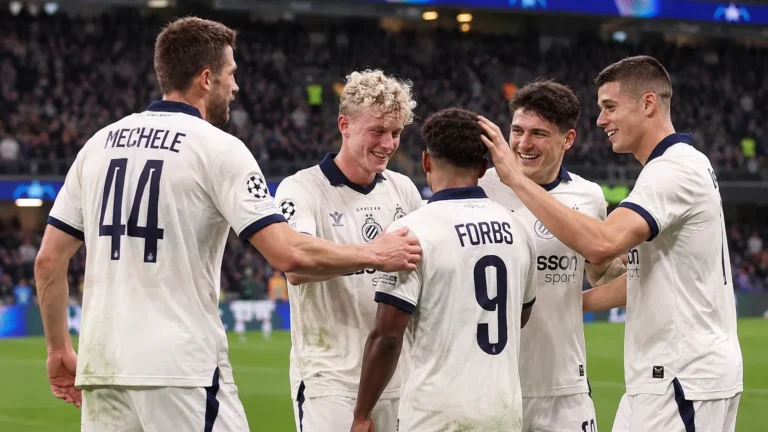 Een groep spelers van Club Brugge viert samen op het veld na de wedstrijd.